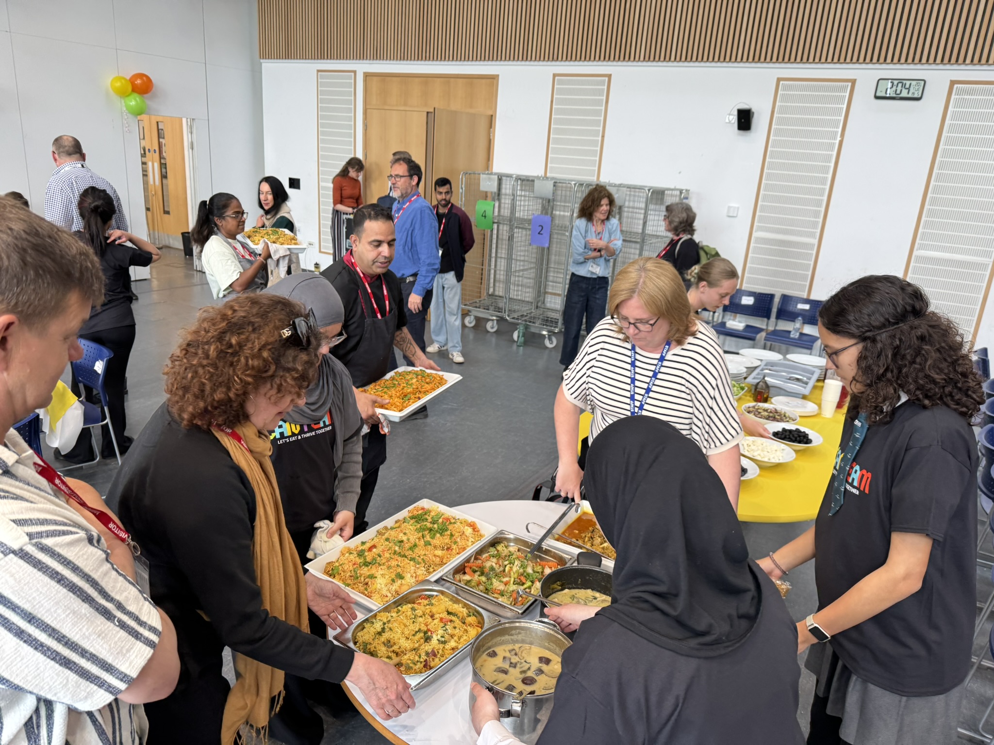 Crew members and guests gathered around the CanTeam buffet at North Durham Academy